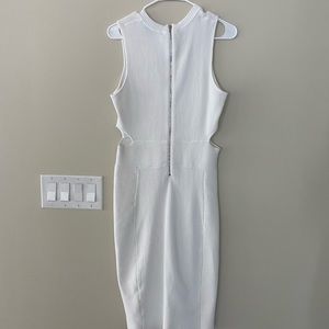 White dress with cut outs on the side. Cut outs are not to drastic.